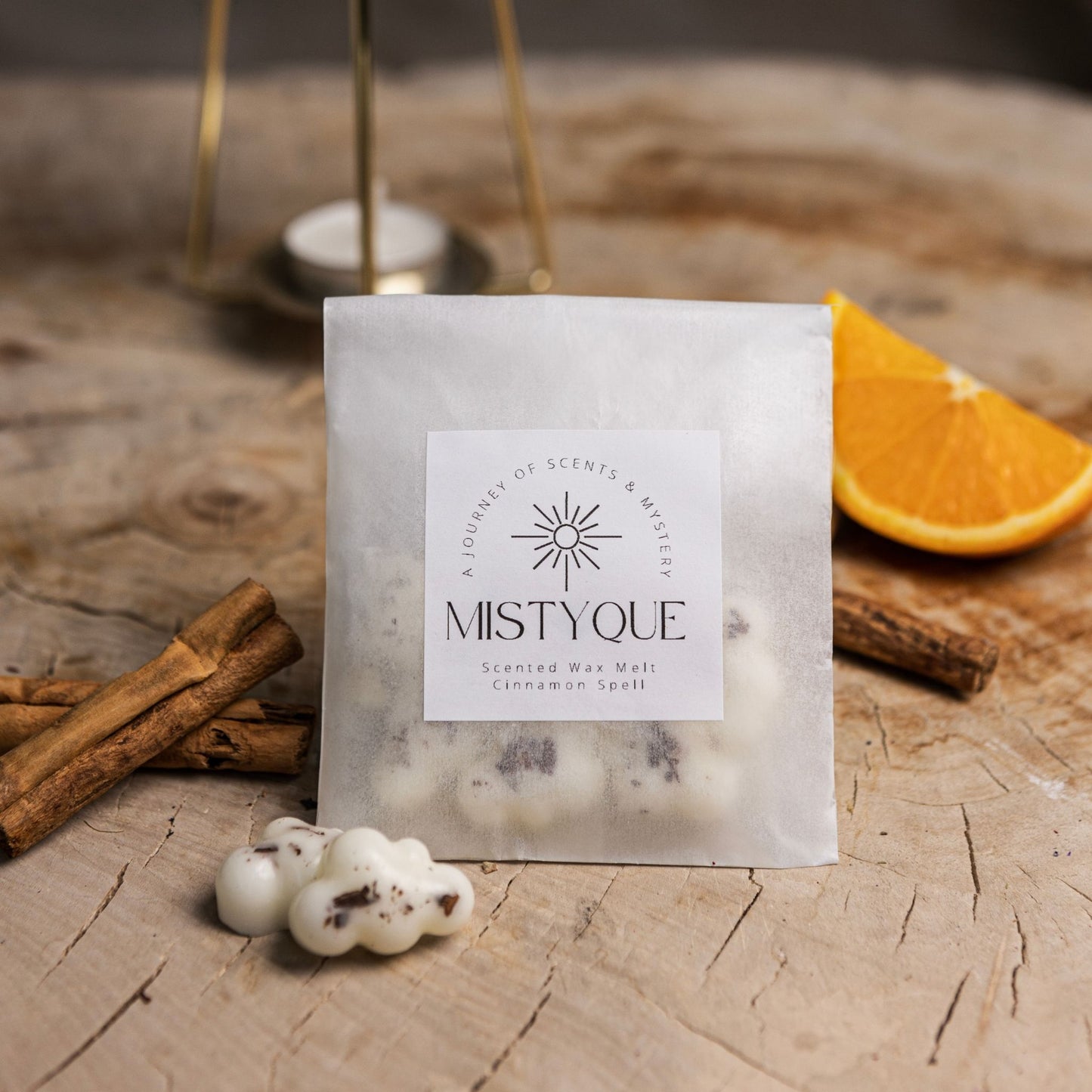 Botanical wax melts with cinnamon sticks and orange slice on kraft background