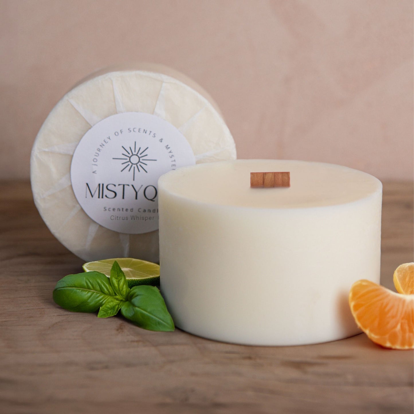 Citrus Whisper refill candle with citrus fruits and basil, next to Mistyque wrap