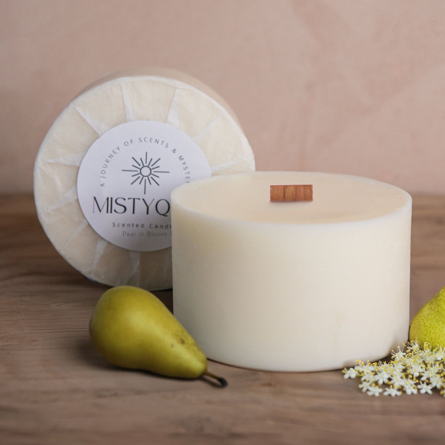 Pear in Bloom refill candle with pear and elderflower, next to Mistyque wrap