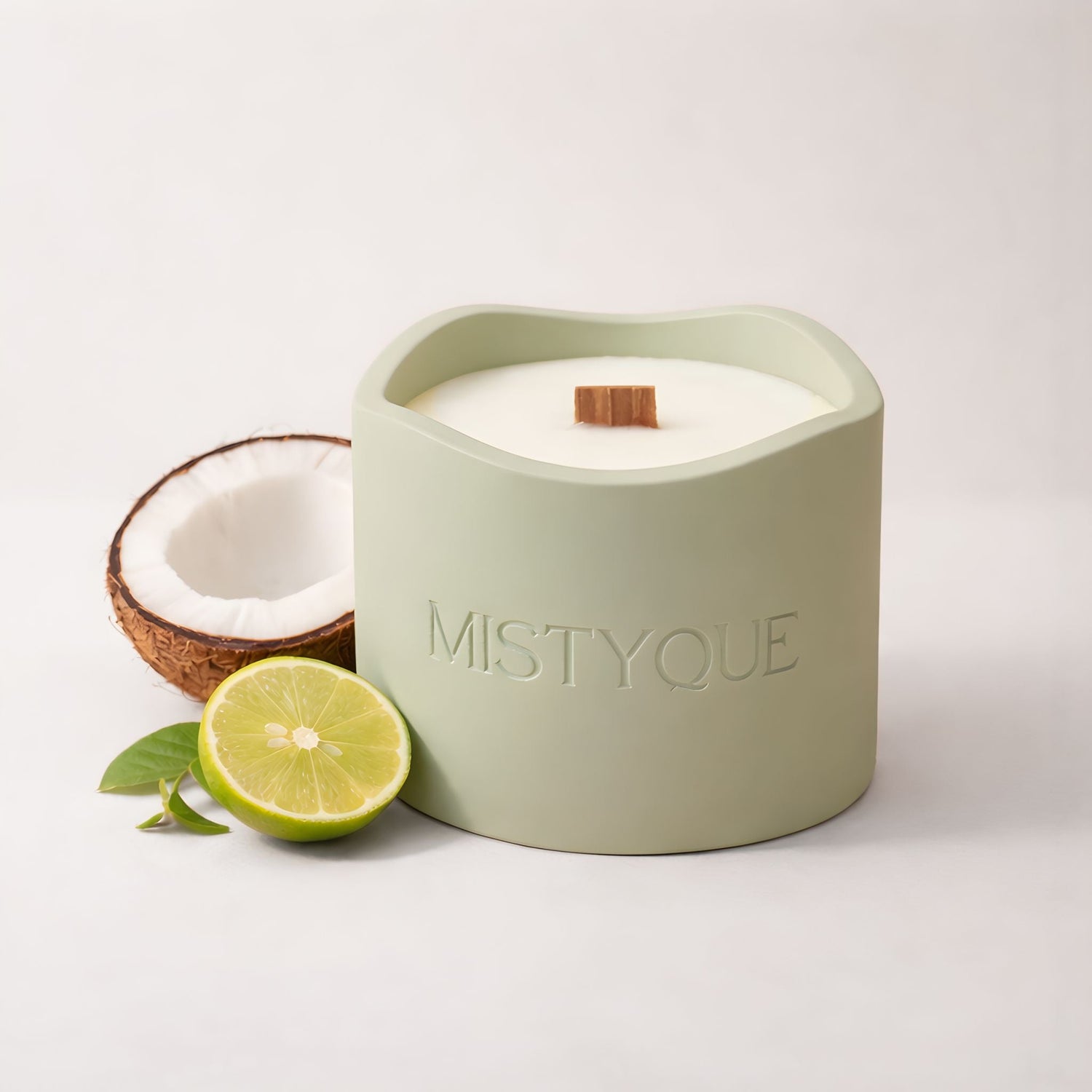Tonka-scented candle in Mistyque ceramic pot surrounded by berries, vanilla, and pine